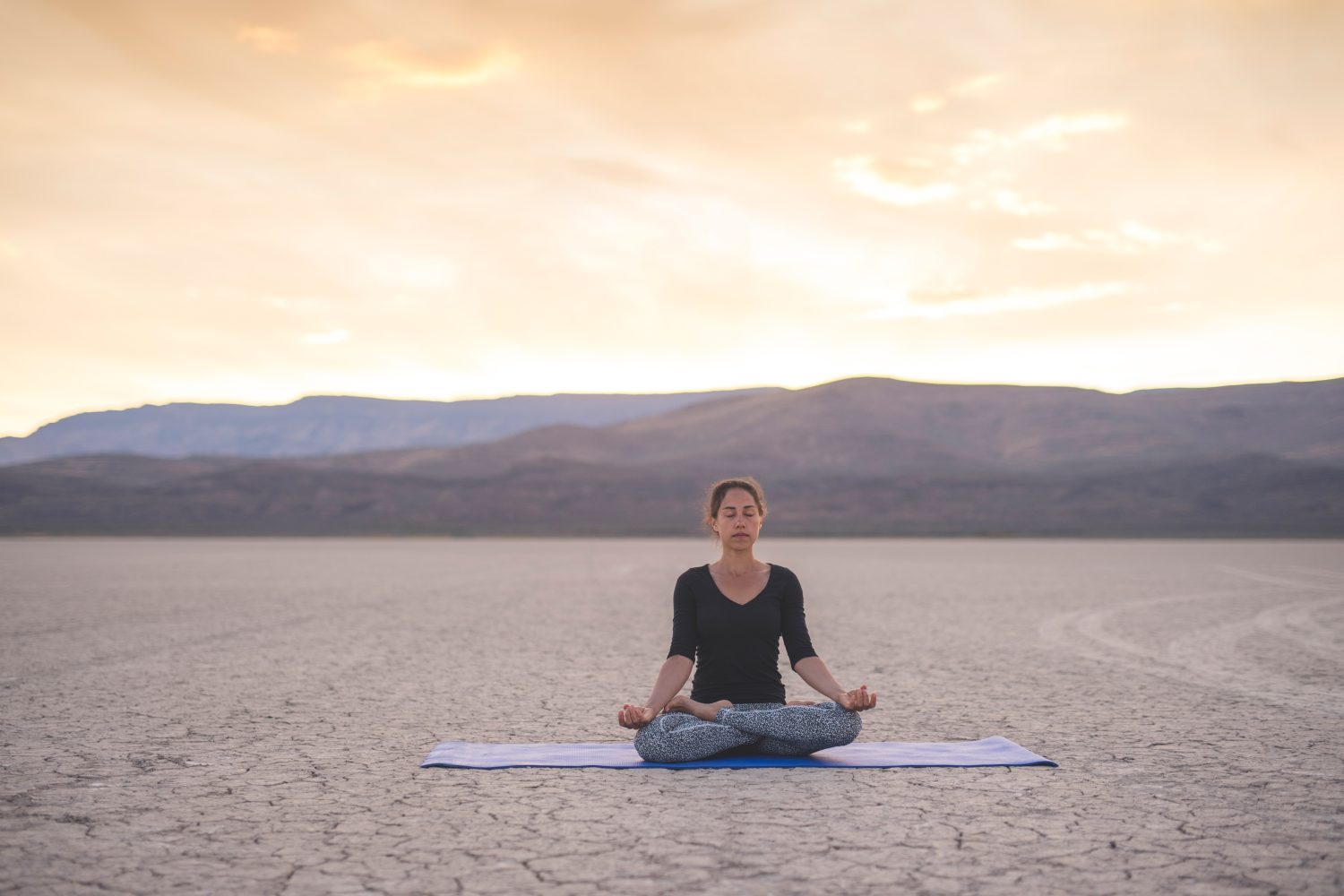 woman doing yoga in the Alvord Desert burns Oregon