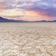 Cracked earth in a dry lakebed in the Alvord desert in southeastern Oregon, USA. A seamlessly stitched panoramic image photographed at sunset. burns Oregon